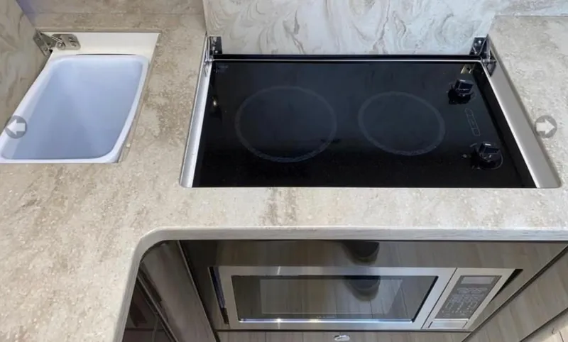 Our Seabatical Yacht Photos Pics Modern kitchen area in a 2014 Formula 45 Yacht with stove and microwave.