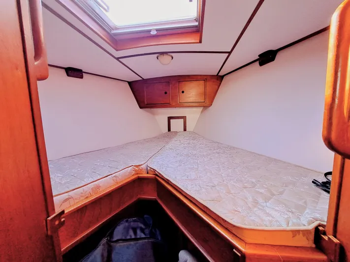  Yacht Photos Pics Cozy cabin interior of 1990 Van De Stadt 44 Deck Saloon yacht with wooden accents.