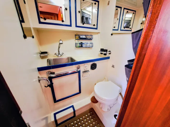  Yacht Photos Pics Compact bathroom in 1990 Van De Stadt 44 Deck Saloon yacht, featuring sink and toilet.