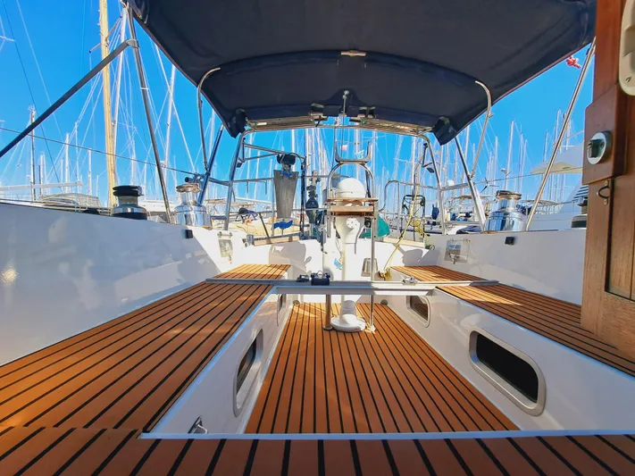  Yacht Photos Pics 1990 Van De Stadt 44 Deck Saloon yacht with teak deck and blue canopy in marina.