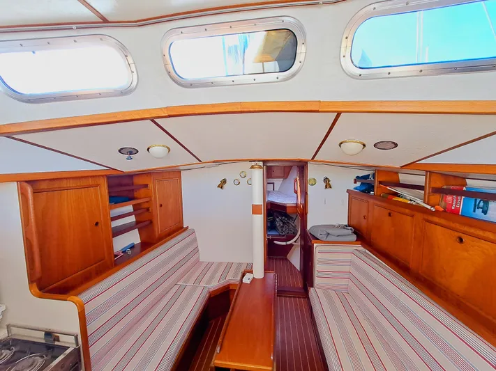  Yacht Photos Pics Interior of 1990 Van De Stadt 44 Deck Saloon with wood finish and seating area.