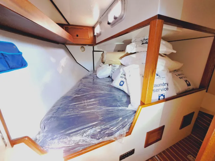  Yacht Photos Pics Cozy cabin interior of 1990 Van De Stadt 44 Deck Saloon, featuring a bed and storage.