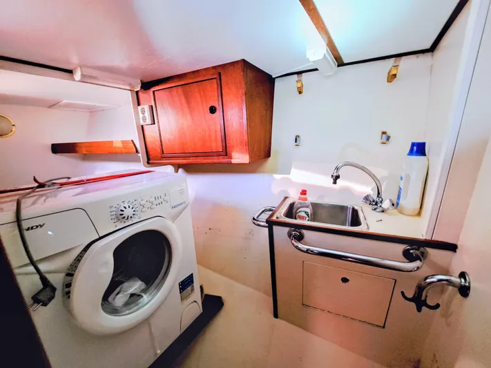  Yacht Photos Pics Laundry area in 1990 Van De Stadt 44 Deck Saloon with washer and sink.