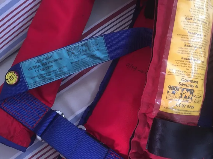  Yacht Photos Pics Red and blue life jacket with safety labels, suitable for Van De Stadt 44 Deck Saloon, 1990.