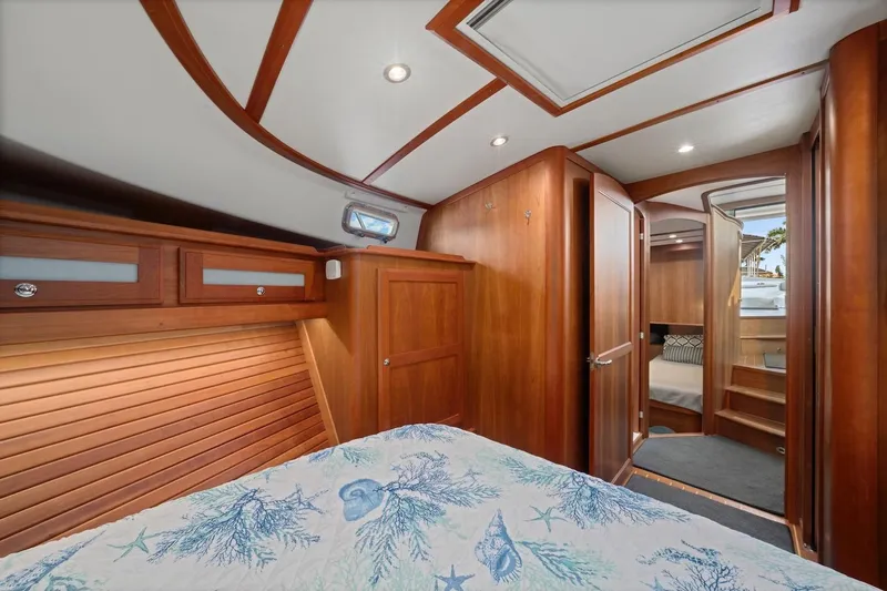 Balahula Yacht Photos Pics Luxurious interior of 2019 Sabre 45 Salon Express yacht with wood finish and cozy bedding.