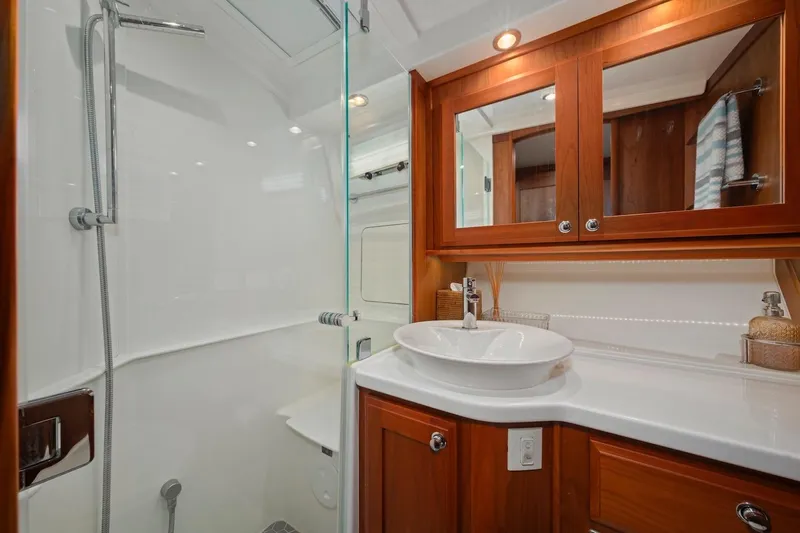 Balahula Yacht Photos Pics Luxurious bathroom in 2019 Sabre 45 Salon Express yacht with wood cabinetry and modern fixtures.
