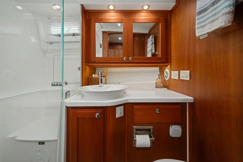 Balahula Yacht Photos Pics Luxurious bathroom in 2019 Sabre 45 Salon Express yacht with wood cabinetry and modern fixtures.
