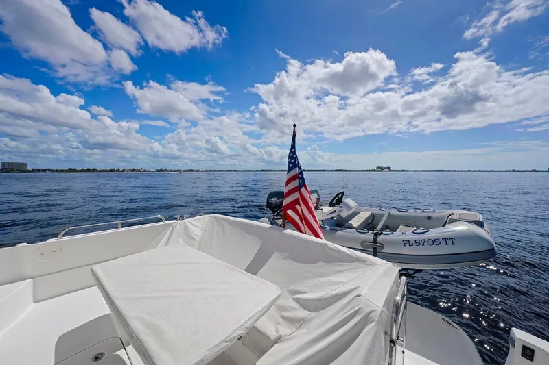Balahula Yacht Photos Pics 2019 Sabre 45 Salon Express yacht with American flag and inflatable boat on open water.