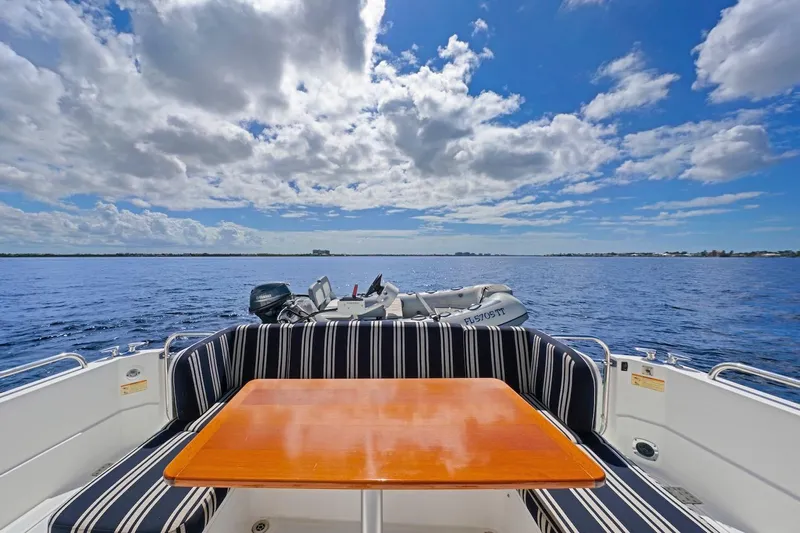Balahula Yacht Photos Pics 2019 Sabre 45 Salon Express yacht with striped seating, wooden table, and ocean view.