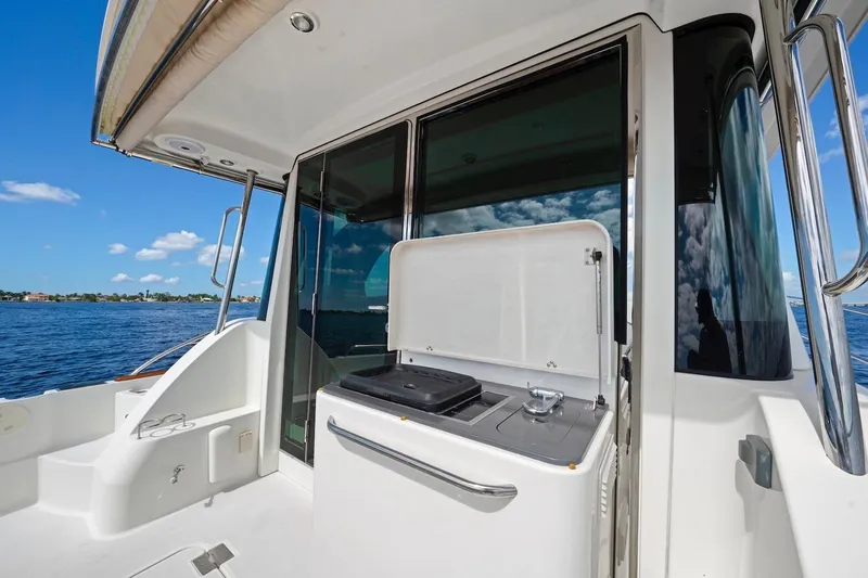 Balahula Yacht Photos Pics 2019 Sabre 45 Salon Express yacht deck with grill, overlooking serene blue waters.