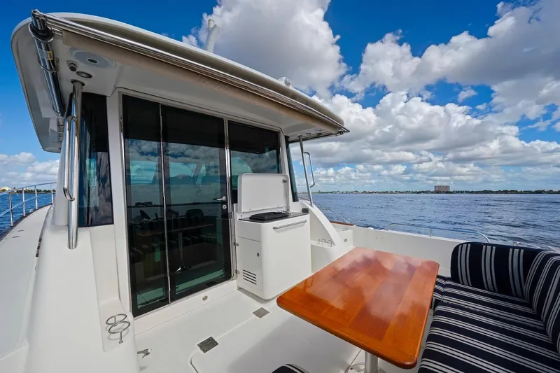 Balahula Yacht Photos Pics 2019 Sabre 45 Salon Express yacht deck with seating, table, and ocean view.