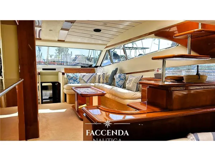  Yacht Photos Pics Luxurious interior of 1999 Ferretti Yachts 68 Anniversary, featuring elegant wood finishes and plush seating.