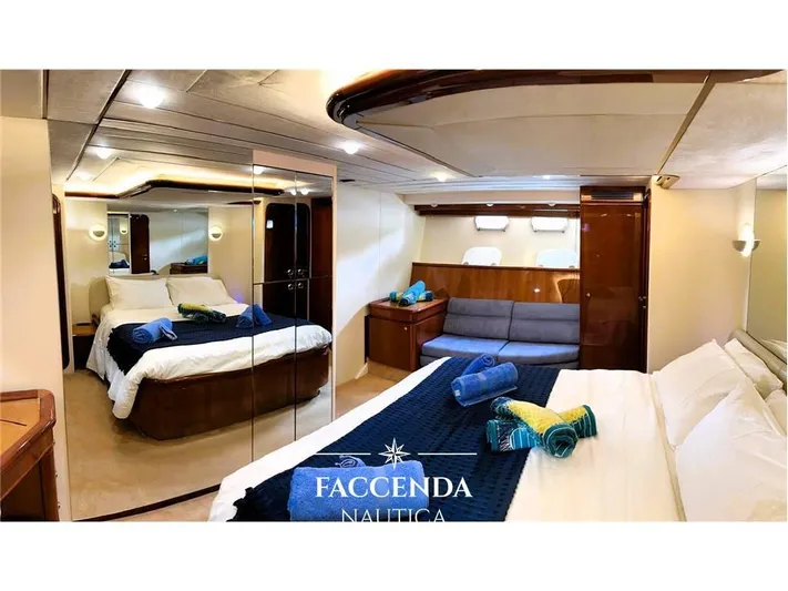 Yacht Photos Pics Luxurious bedroom interior of 1999 Ferretti Yachts 68 Anniversary, featuring elegant design and cozy ambiance.