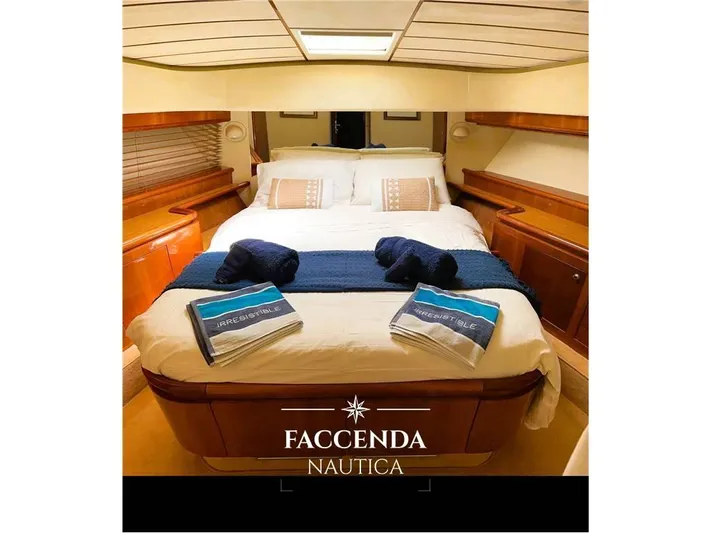  Yacht Photos Pics Luxurious bedroom interior of 1999 Ferretti Yachts 68 Anniversary, featuring elegant bedding and wood finishes.