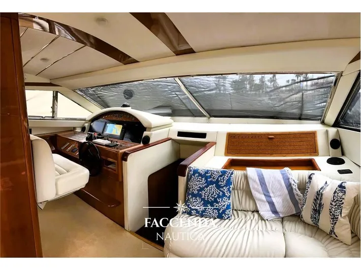  Yacht Photos Pics Luxurious interior of 1999 Ferretti Yachts 68 Anniversary with plush seating and modern helm.