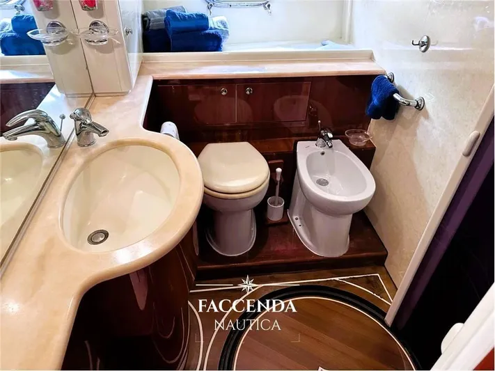  Yacht Photos Pics Luxurious bathroom in 1999 Ferretti Yachts 68 Anniversary, featuring elegant fixtures and wood accents.
