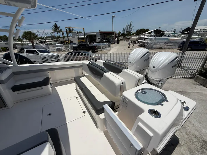 317-125 Yacht Photos Pics 2024 Robalo R317 Dual Console boat with seating and twin engines, docked outdoors.
