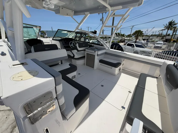 317-125 Yacht Photos Pics 2024 Robalo R317 Dual Console boat interior with seating and helm, docked outdoors.