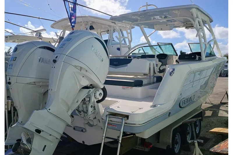 317-125 Yacht Photos Pics 2024 Robalo R317 Dual Console boat with twin Yamaha outboard engines, docked on a trailer.