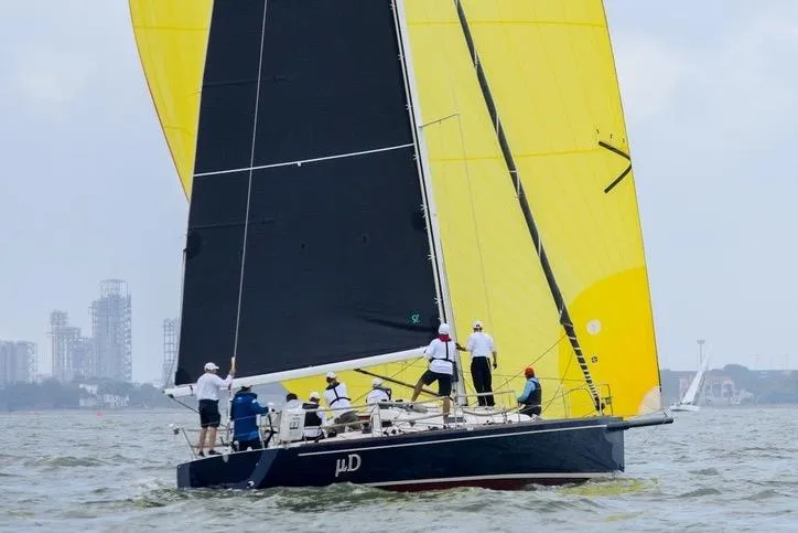 Microdarcy(ud) Yacht Photos Pics Sailing yacht J/124 from 2005 with vibrant yellow and black sails on open water.