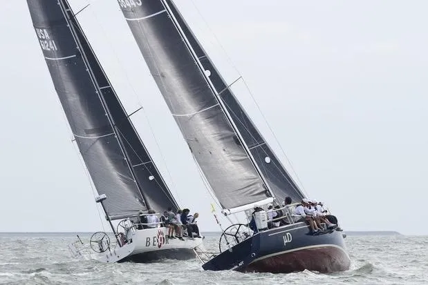 Microdarcy(ud) Yacht Photos Pics Two J/124 sailboats racing on the water, showcasing sleek design and performance.