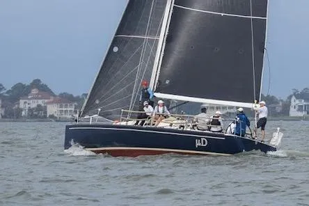 Microdarcy(ud) Yacht Photos Pics 2005 J Boats J/124 sailing on a calm sea with crew onboard.