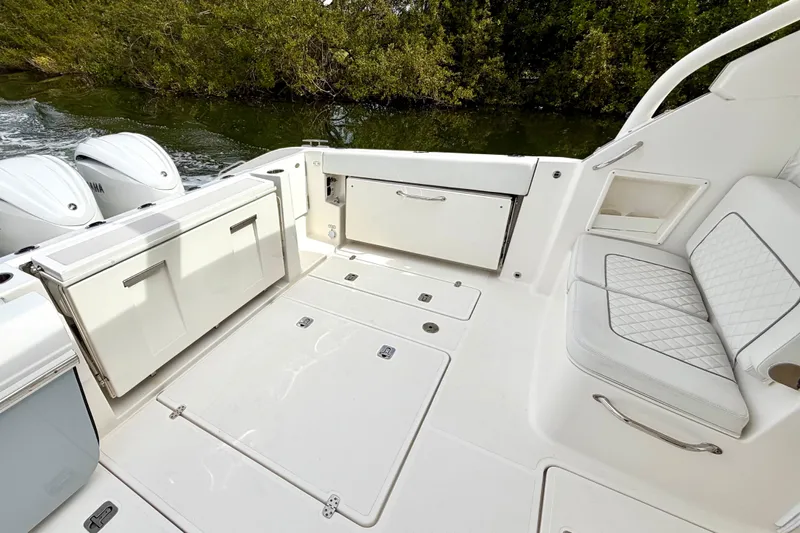  Yacht Photos Pics 2024 Pursuit DC 365 Dual Console boat interior with seating and storage compartments.
