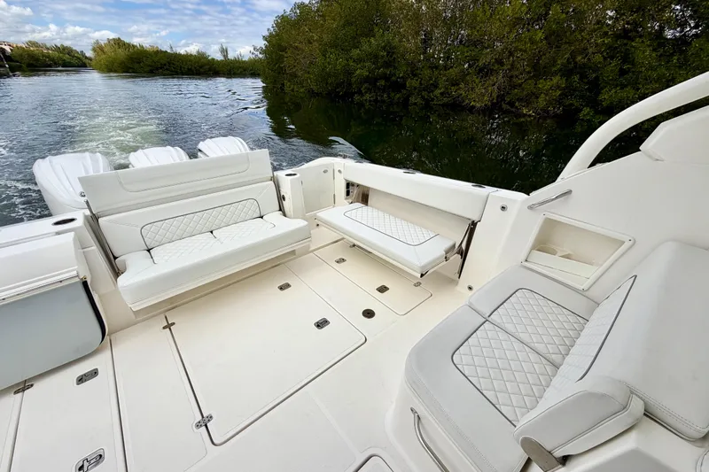  Yacht Photos Pics 2024 Pursuit DC 365 Dual Console boat interior with luxurious seating and scenic water view.