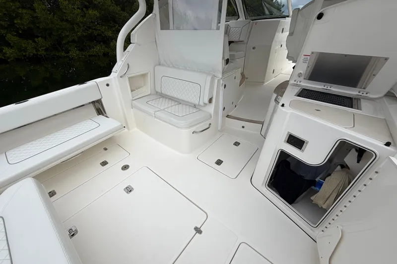  Yacht Photos Pics 2024 Pursuit DC 365 Dual Console boat interior with seating and storage compartments.