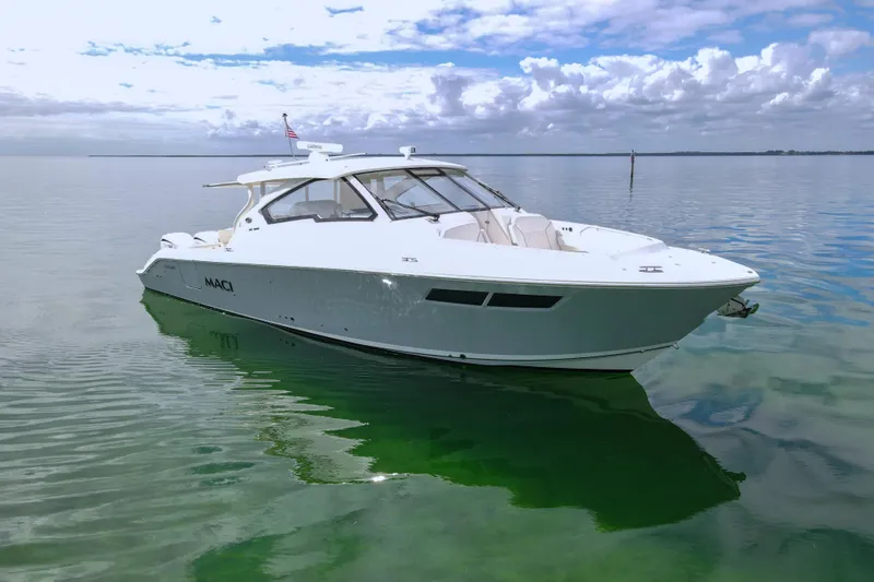  Yacht Photos Pics 2024 Pursuit DC 365 Dual Console boat on calm water under cloudy sky.