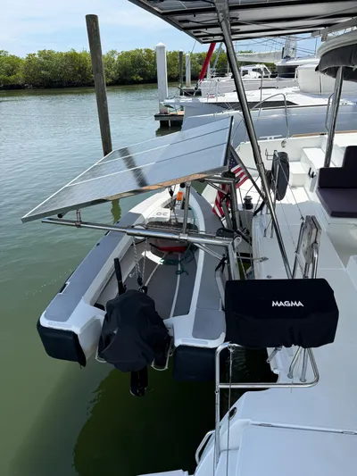 Escapist Yacht Photos Pics 2018 Lagoon 400 S2 catamaran with solar panels docked in a serene marina.