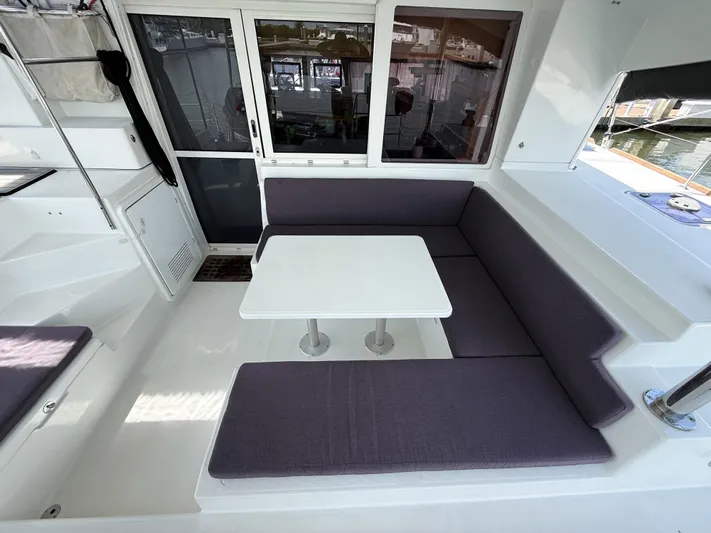 Escapist Yacht Photos Pics Interior of 2018 Lagoon 400 S2 catamaran with seating area and table.