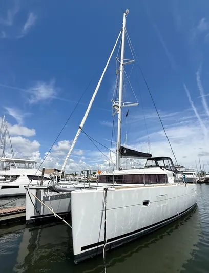 Escapist Yacht Photos Pics 2018 Lagoon 400 S2 catamaran docked under a clear blue sky.