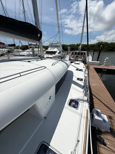 Escapist Yacht Photos Pics 2018 Lagoon 400 S2 catamaran docked at marina under blue sky.