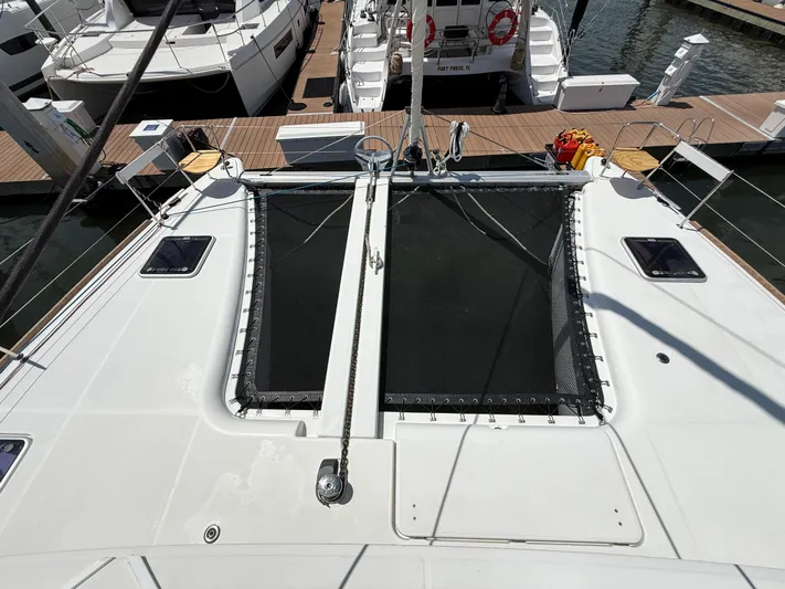 Escapist Yacht Photos Pics 2018 Lagoon 400 S2 catamaran docked, featuring spacious deck and netting area.