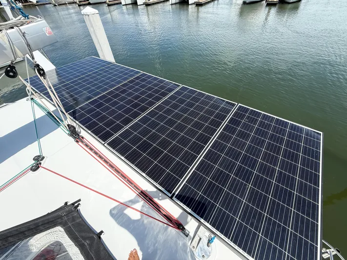 Escapist Yacht Photos Pics Solar panels on a 2018 Lagoon 400 S2 catamaran docked at a marina.