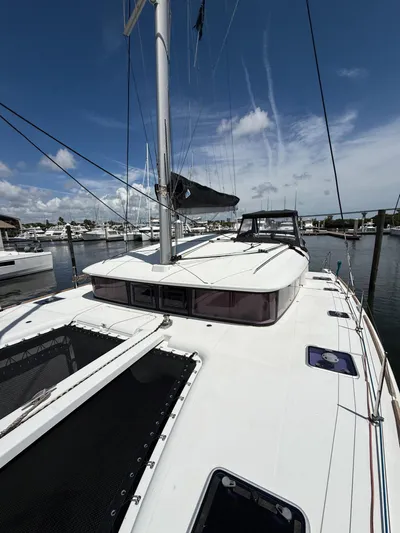 Escapist Yacht Photos Pics 2018 Lagoon 400 S2 catamaran docked at marina under clear blue sky.