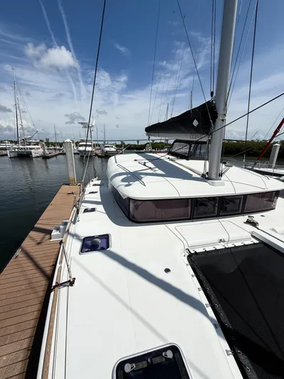 Escapist Yacht Photos Pics 2018 Lagoon 400 S2 catamaran docked at marina under clear blue sky.