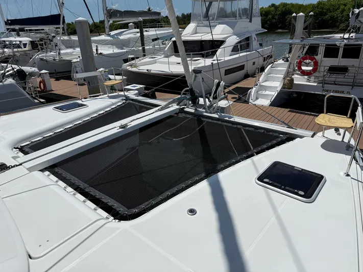 Escapist Yacht Photos Pics 2018 Lagoon 400 S2 catamaran docked among other boats at a marina.