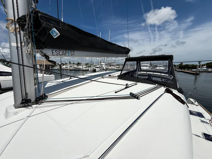 Escapist Yacht Photos Pics 2018 Lagoon 400 S2 catamaran docked at marina under clear blue sky.