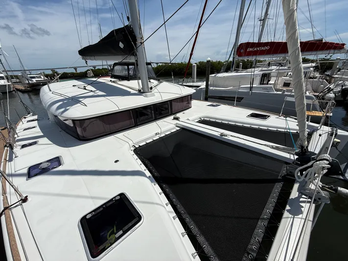 Escapist Yacht Photos Pics 2018 Lagoon 400 S2 catamaran docked at marina, featuring spacious deck and sleek design.