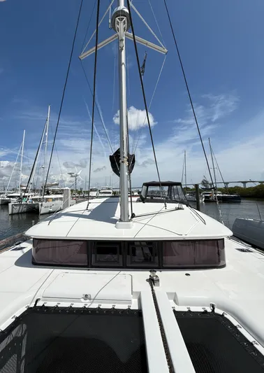 Escapist Yacht Photos Pics 2018 Lagoon 400 S2 catamaran docked under clear blue sky.