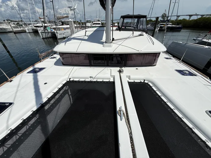 Escapist Yacht Photos Pics 2018 Lagoon 400 S2 catamaran docked at marina, showcasing deck and netting.