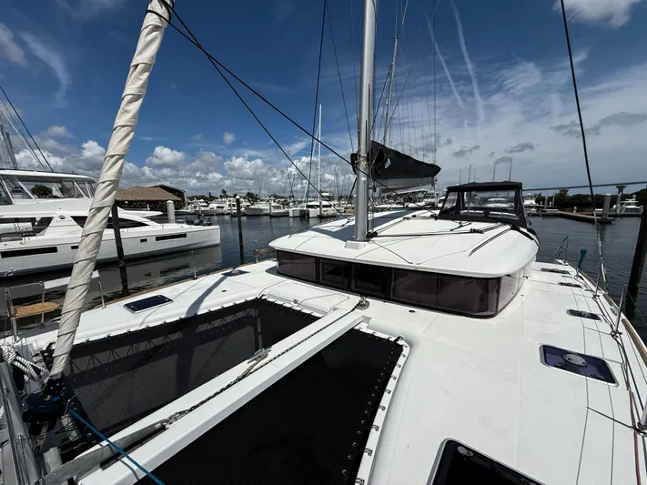 Escapist Yacht Photos Pics 2018 Lagoon 400 S2 catamaran docked at marina under blue sky.