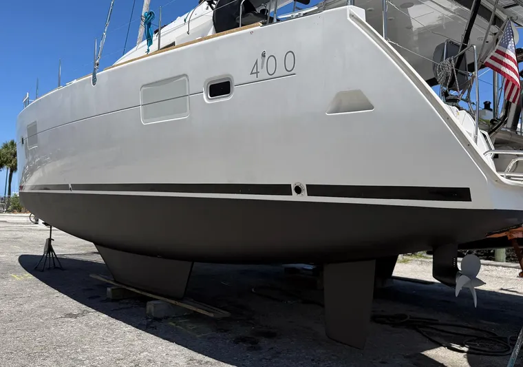 Escapist Yacht Photos Pics 2018 Lagoon 400 S2 catamaran on dry dock, showcasing hull and rudder design.