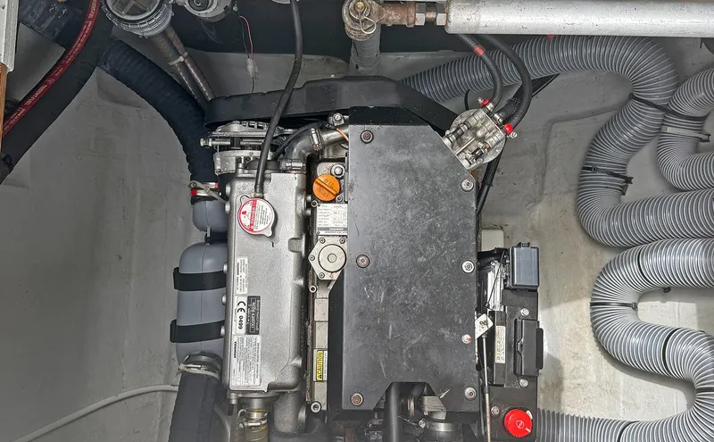 Escapist Yacht Photos Pics Engine compartment of a 2018 Lagoon 400 S2 catamaran with visible hoses and components.
