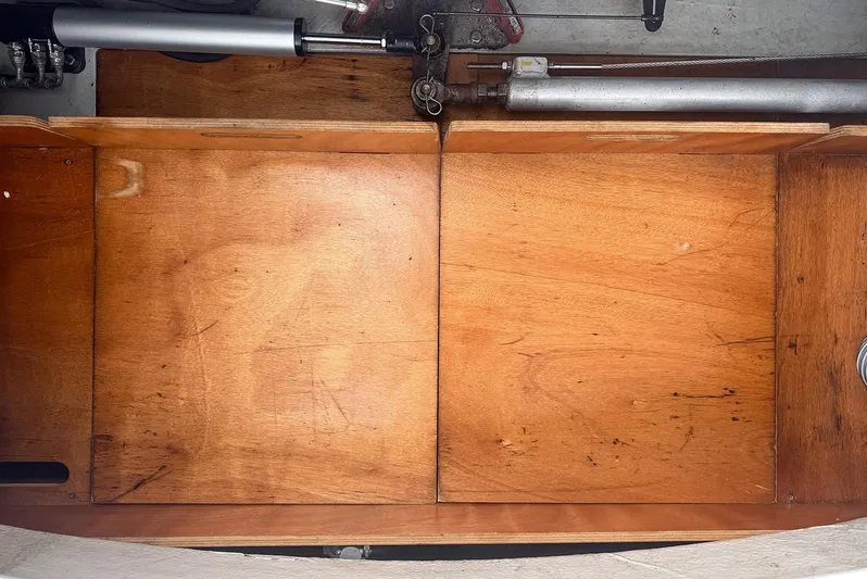 Escapist Yacht Photos Pics Wooden compartment interior of a 2018 Lagoon 400 S2 yacht, showcasing mechanical components.