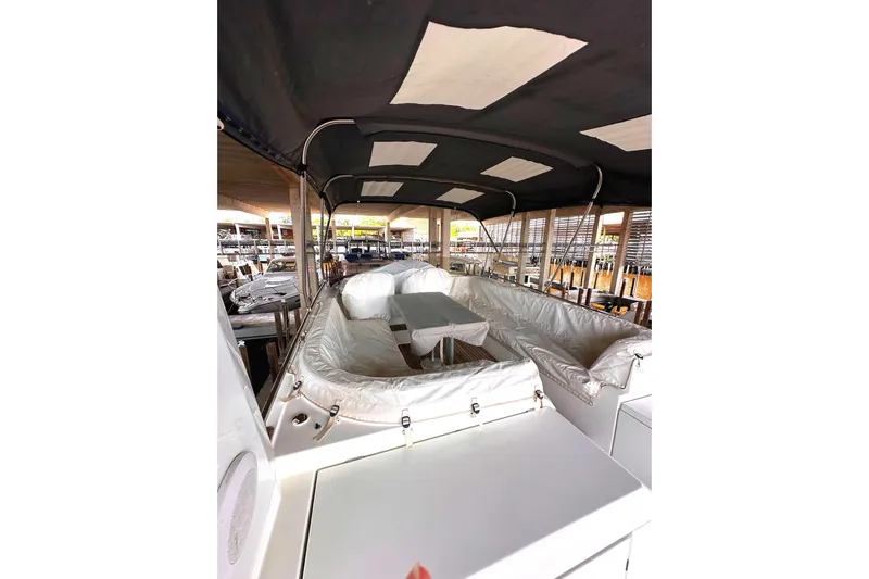 Dove Yacht Photos Pics 2015 Beneteau Swift Trawler 50 interior with cushioned seating and table under canopy.