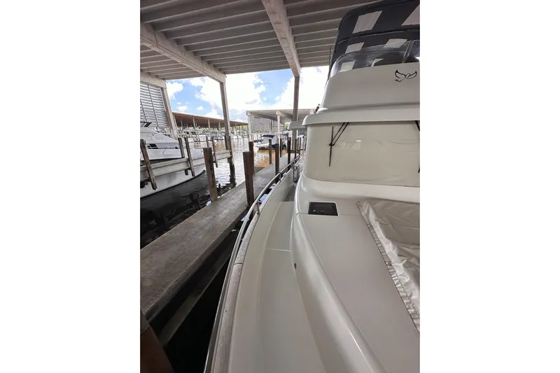 Dove Yacht Photos Pics 2015 Beneteau Swift Trawler 50 docked in a covered marina.