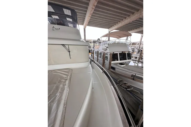 Dove Yacht Photos Pics 2015 Beneteau Swift Trawler 50 docked under a covered marina.